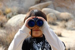woman looking through binoculars